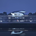 Modern Museum Building With Streamlined Design Night Lighting And Water Reflection
