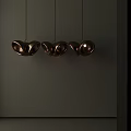 Three Modern Copper Butterfly Shaped Pendant Lights With Warm Glow In Minimalist Interior