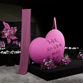 Elegant Banquet Hall With Purple Pink Floral Decorations And Geometric Backdrop Setup