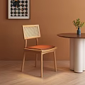 Wooden Dining Chair With Rattan Back And Brown Cushion Orange Wall Round Table And Plant