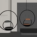 Modern Hanging Chair with Round Metal Frame and Gray Brown Cushions in Interior Space