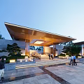 Modern Illuminated Residential Building Exterior With Extended Roof And Landscaped Gardens And Stone Steps