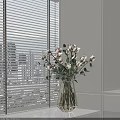 White Roses With Greenery In Transparent Golden Frame Vase On White Cabinet By Window Blinds