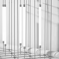 Modern Chandelier with Slim Silver Rods and White Elongated Lights Neatly Arranged with Shadows