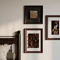 Warm Bedroom Photo Wall Decor With Three Framed Artworks And Wooden Bedhead And Soft Pillows