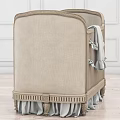 Classic Beige Upholstered Baby Crib With Bow Ties Soft Blanket And Ruffled Skirt