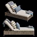 Wicker Lounge Chair with Beige Cushion Striped Pillows and Blue Throw Blanket