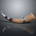 Brown Horn Household Item With Silver Metal Decorative Rings And Reflective Surface