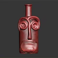 Red Face Shaped Ceramic Vessel With Artistic Eye And Mouth Design On Dark Surface