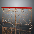 Ornate Gold Metal Fence With Curved Scroll Design And Red Top