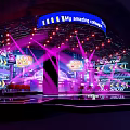 Dynamic Stage Design Featuring Purple Lighting LED Screens And Blue Amazing Collage Banner