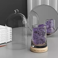 Perfume Cosmetics Display Featuring Transparent Glass Cloche Blue Ice Cubes Wooden Base and Open Book