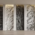 Four Textured Stone Wall Panels With White Frames Light Wood Floor And Potted Plant