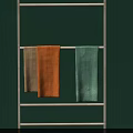 Beige Orange And Light Green Towels Hanging On Metal Rack Against Green Wall