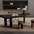 Modern Black Desk With Open Book And Table Lamp And Wooden Stools On Woven Rug