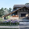 Traditional Ancient Building With Stone Walls Sloped Roof And Lush Garden Plants