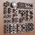 Various Shaped Metal Profiles With Geometric Hollow Patterns On Wooden Background 3d model