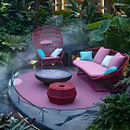 Pink Rattan Outdoor Sofa With Blue Cushions In Tropical Garden With Water Feature And Mist