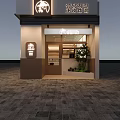 Modern Dessert Shop Exterior With Glass Facade Bright Lighting And Indoor Seating
