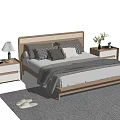 Double Bed With Wooden Headboard Nightstands Table Lamps Pillows Blanket Small Plants And Rug