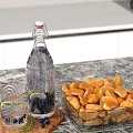 Clear Glass Bottle Black Berries And Orange Carrot Slices Decorative Ornaments Set On Marble Tabletop