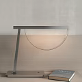 Modern Minimalist Table Lamp With Metal Frame And Glass Shade On Wooden Desk