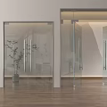 Modern Transparent Glass Double Doors In Interior With Wooden Flooring And Green Plants