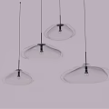 Three Modern Transparent Cloud Shaped Chandeliers Hanging Lit Against Grey Background