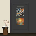 Two Abstract Paintings On Dark Wall With Colorful Brush Strokes And Decorative Vase
