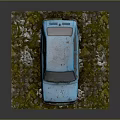 Abandoned Old Blue Rusty Car Parked On Stony Ground With Weeds