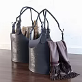 Chic Leather Storage Baskets with Black Handles Holding Firewood and Blanket Tassels