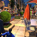 Vibrant Commercial Street With Outdoor Dining Seats Pedestrians Green Plants And Modern Shopfronts
