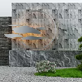 Garden Ornament Featuring Stone Wall Circular Metal Decor Cloud Shaped Pieces Green Plants and Grass