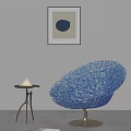 Sculptural Blue Leisure Chair With Intricate Hollowed Texture And Side Table In Modern Living Space