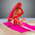 Blonde Girl In Red Top On Pink White Striped Blanket With Pink Surfboard At Beach