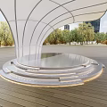 Modern Outdoor Curved Canopy Structure With Circular Platform Wooden Deck Trees And Buildings