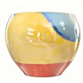Glossy Ceramic Vessel With Yellow Blue Red Colors And Vibrant Glazed Design