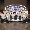 Traditional Cultural Exhibition Hall Featuring Circular Ceiling Pattern And Illuminated Display Stands