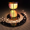 Giant Illuminated Hourglass In Night Scene With Surrounding Light Poles
