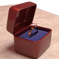 Elegant Red Jewelry Box With Blue Cushion Holding Pink Gemstone Ring