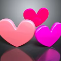 Three Shiny Heart Shapes In Light Pink Red And Bright Pink With Reflection