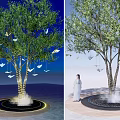Arbor Tree With Illuminated Base Hanging Butterfly Decorations And Woman In White Dress