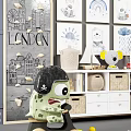 Green Monster Stuffed Toy in Kids Room with Decorative Wall Art Storage Cabinet and Building Blocks