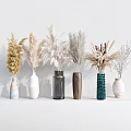 Various Materials And Colored Vases With Dried Flowers On Light Countertop Against White Wall