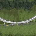 Scenic Curved Landscape Bridge with People Walking Amid Green Trees and Grass