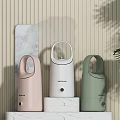 Pastel Pink White And Green Daily Use Humidifiers On Marble Countertop With Striped Wall
