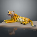 Yellow Black Striped Tiger Model Lying On Light Colored Platform With Gray Background