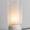 Modern White Table Lamp With Circular Perforated Shade And Warm Glow