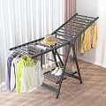 Foldable Clothes Drying Rack With Hanging Clothes Hat And Shoes On Wooden Floor