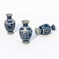 Three Ceramic Vases with Blue and White Floral Patterns One Tilted Isolated on White Background